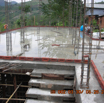 New iron rods for first floor are being joined as the concrete flat is being watered